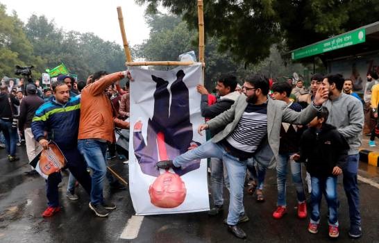 Musulmanes indios patean un poste con la imagen de Donald Trump durante una protesta en Nueva Delhi, hoy martes 7 de enero del 2019.(Foto: Rajat Gupta, EFE, EPA)