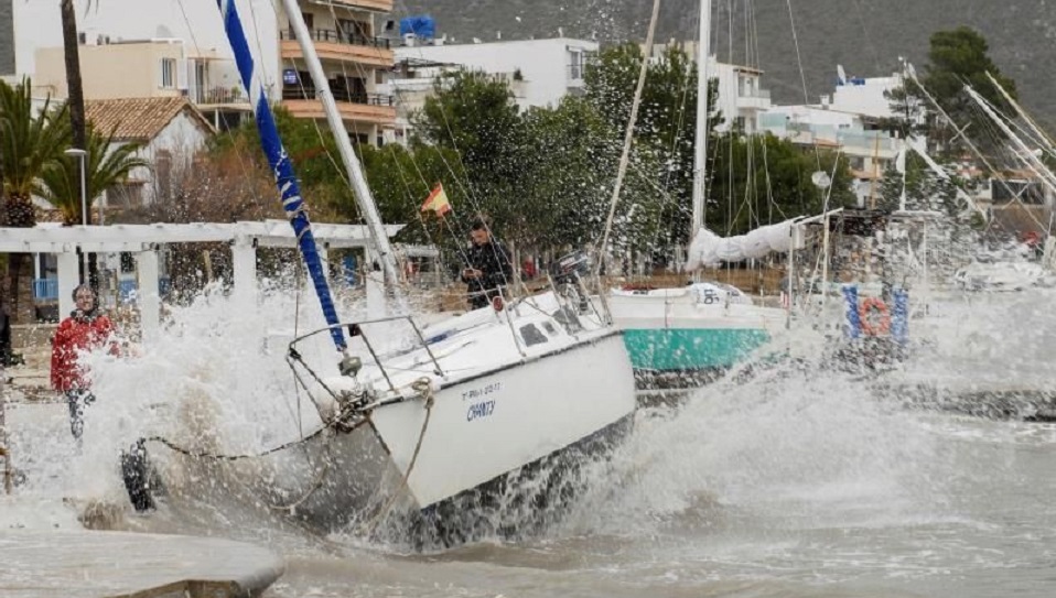El temporal arrastró ayer una quincena de embarcaciones hasta la arena en el Port de Pollença (Mallorca). (Foto: EFE)